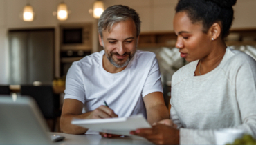 Man helping woman with finances